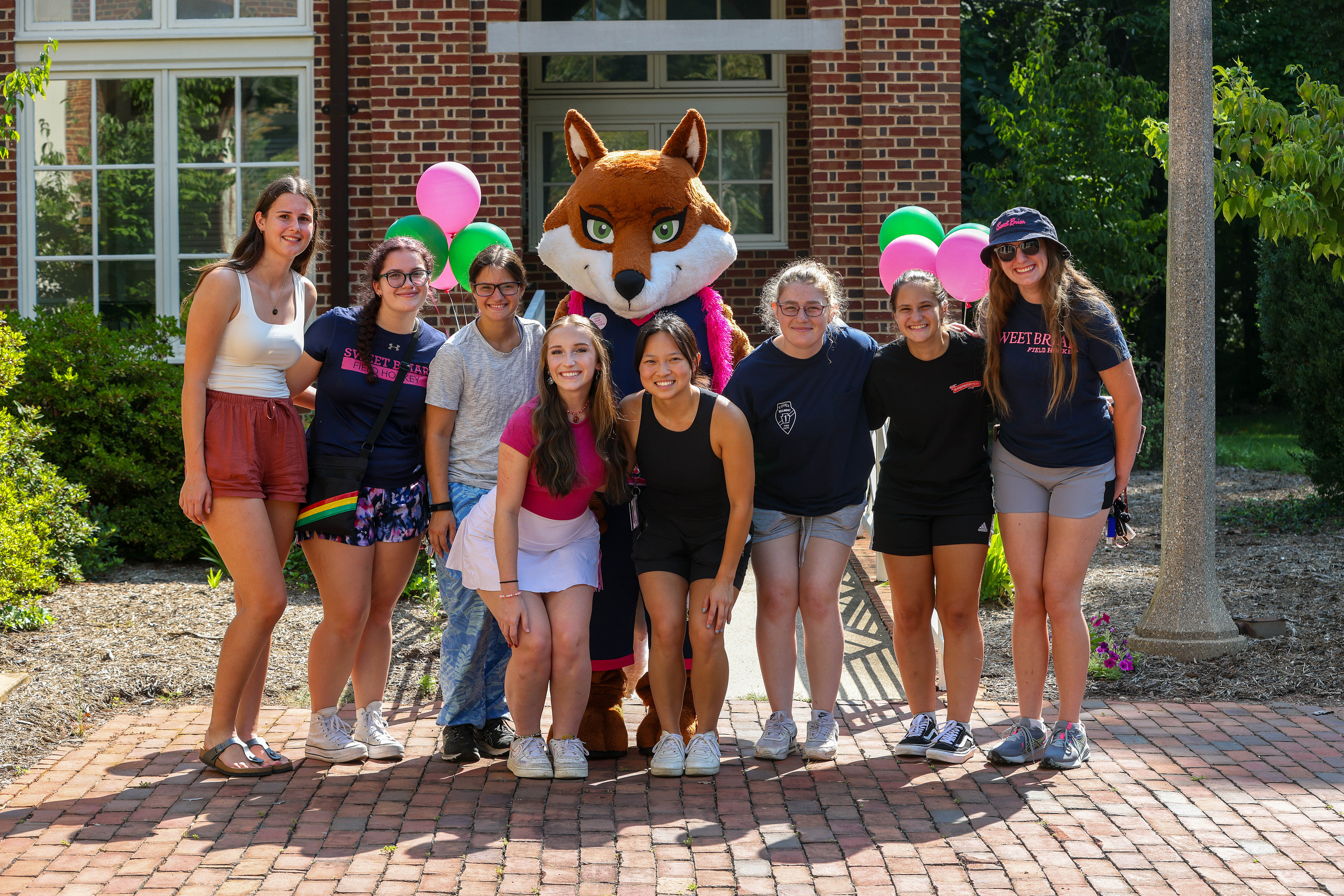 Girls pose with mascot